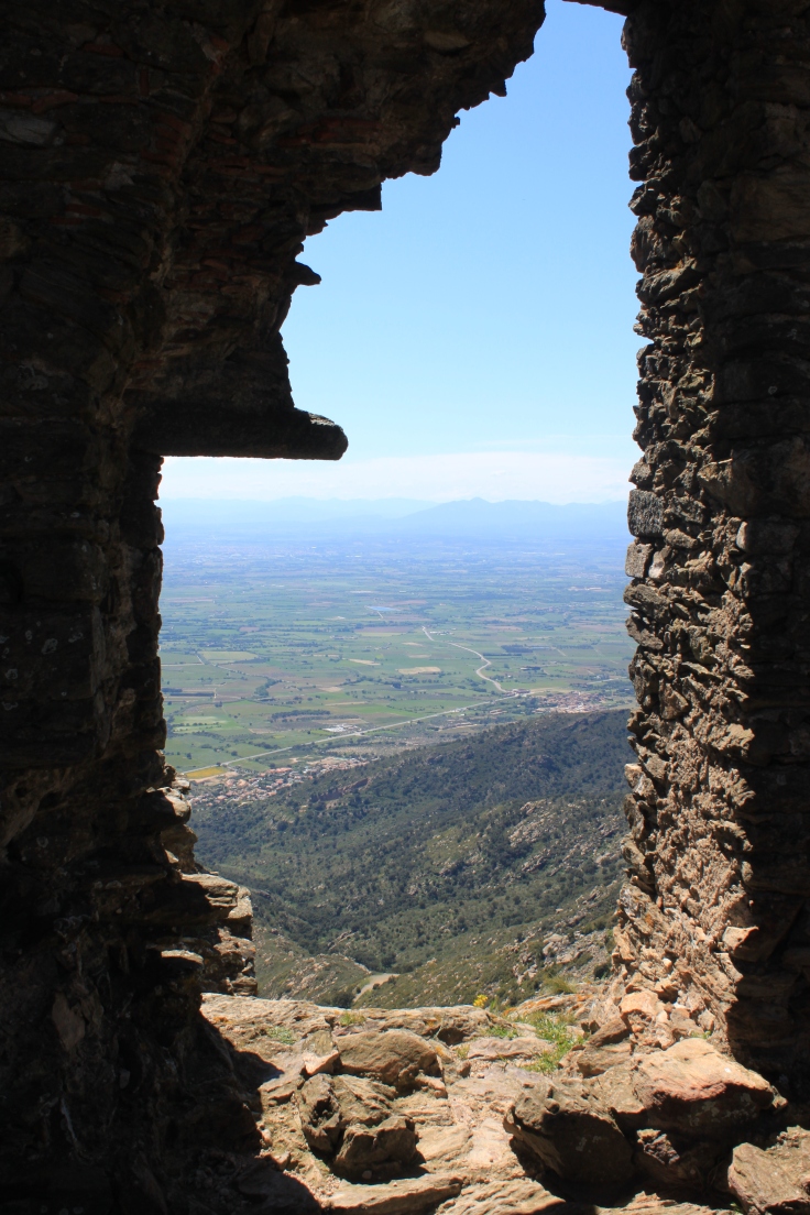 Spain, as seen through a window of Castell de Sant Salvador, above Sant Pere de Rodes.